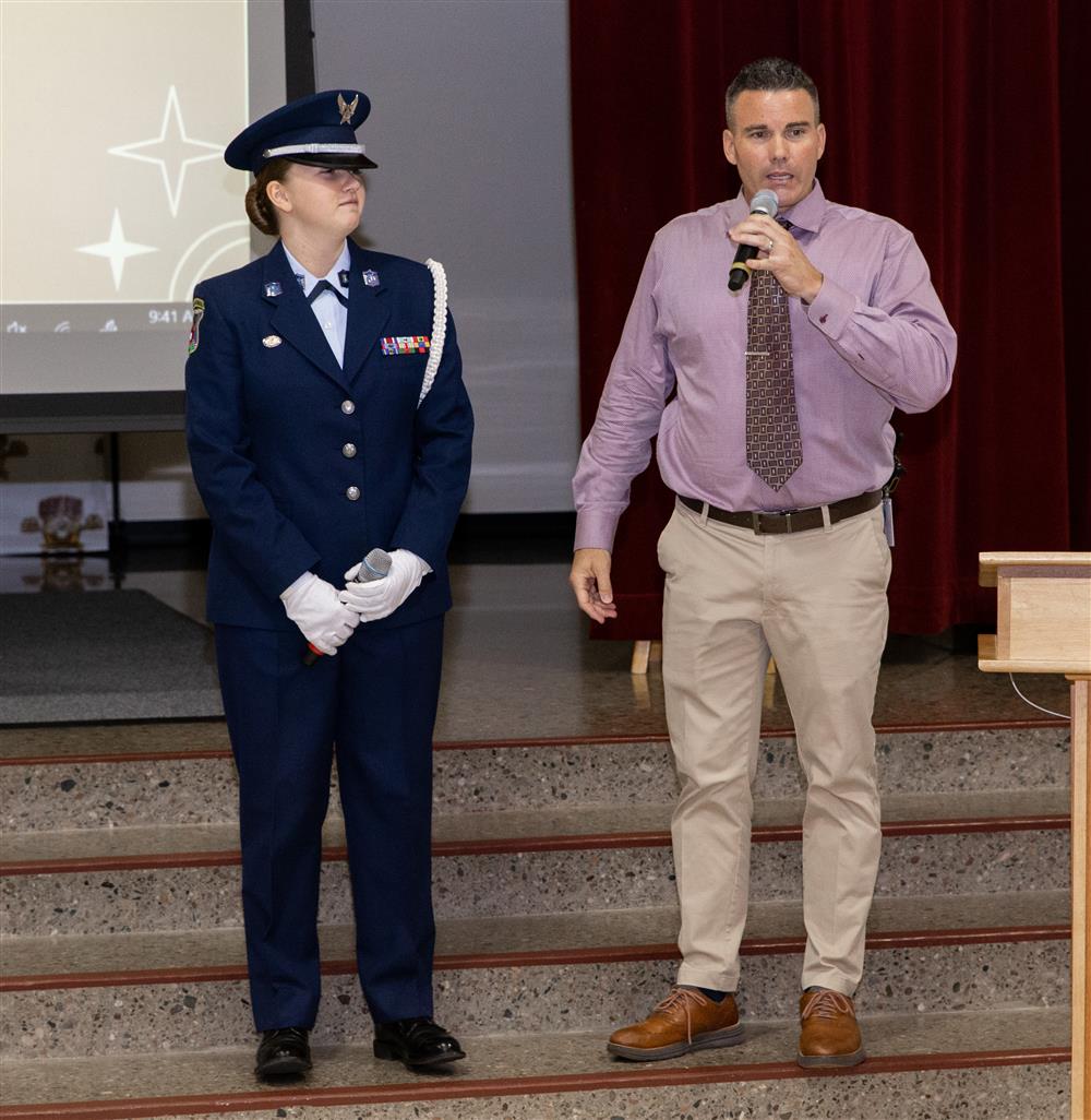 Carlson Elementary Principal Andy Morgan talks with a Basha High ROTC student and former Carlson Champion.